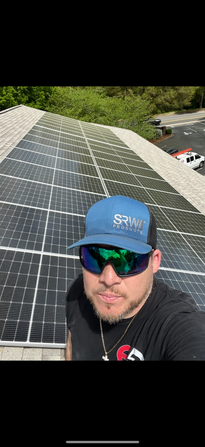 Rooftop solar array with technician on the roof