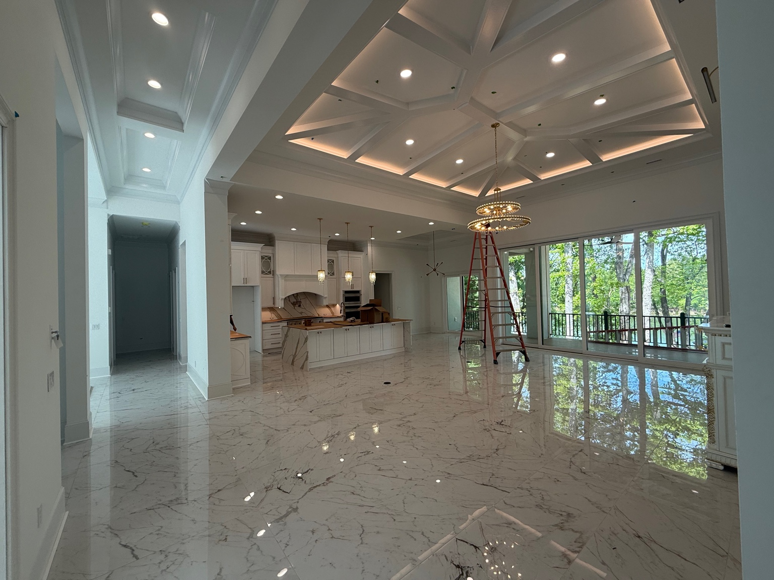 Open kitchen and living area with coffered lighting